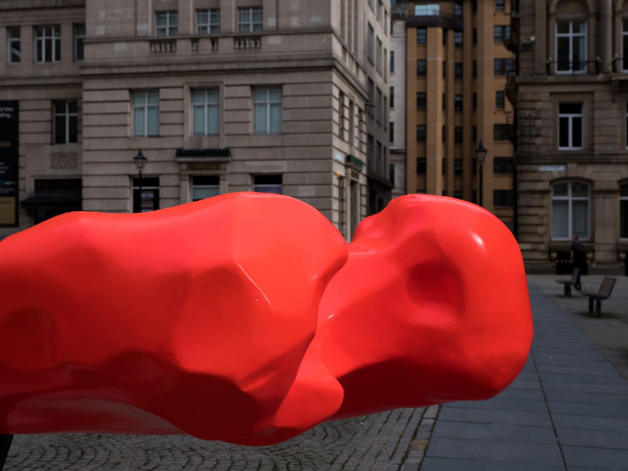 A close up shot of a bright red, bone shaped canoe.