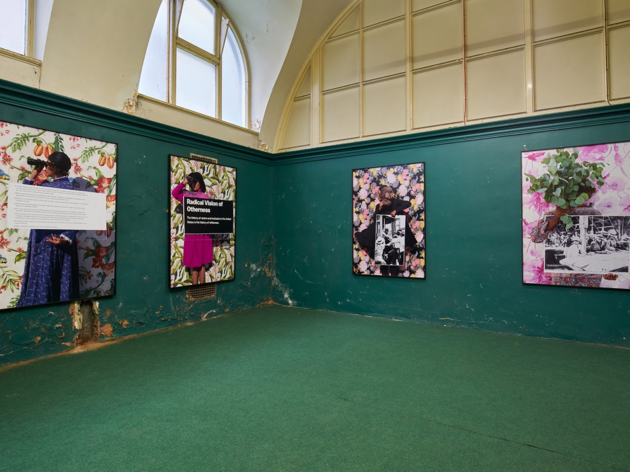 Four large flat artworks on the walls of Cotton Exchange, the artworks have flowery assets to them. The space had dark green walls and a green carpet.