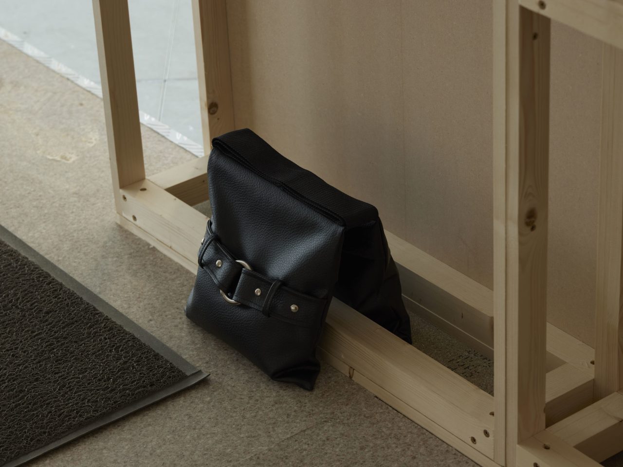 A leather artwork with a buckle on the front