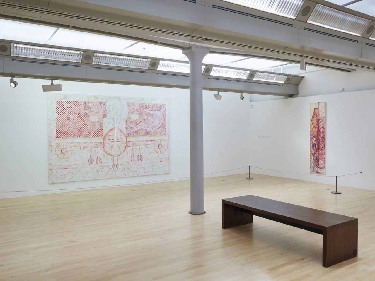 A large painting on a wall with red, pink and orange patterns and mark making, showing the facing angle of an aeroplane, and a long vertical painting with orange, pink and purple abstract markings.