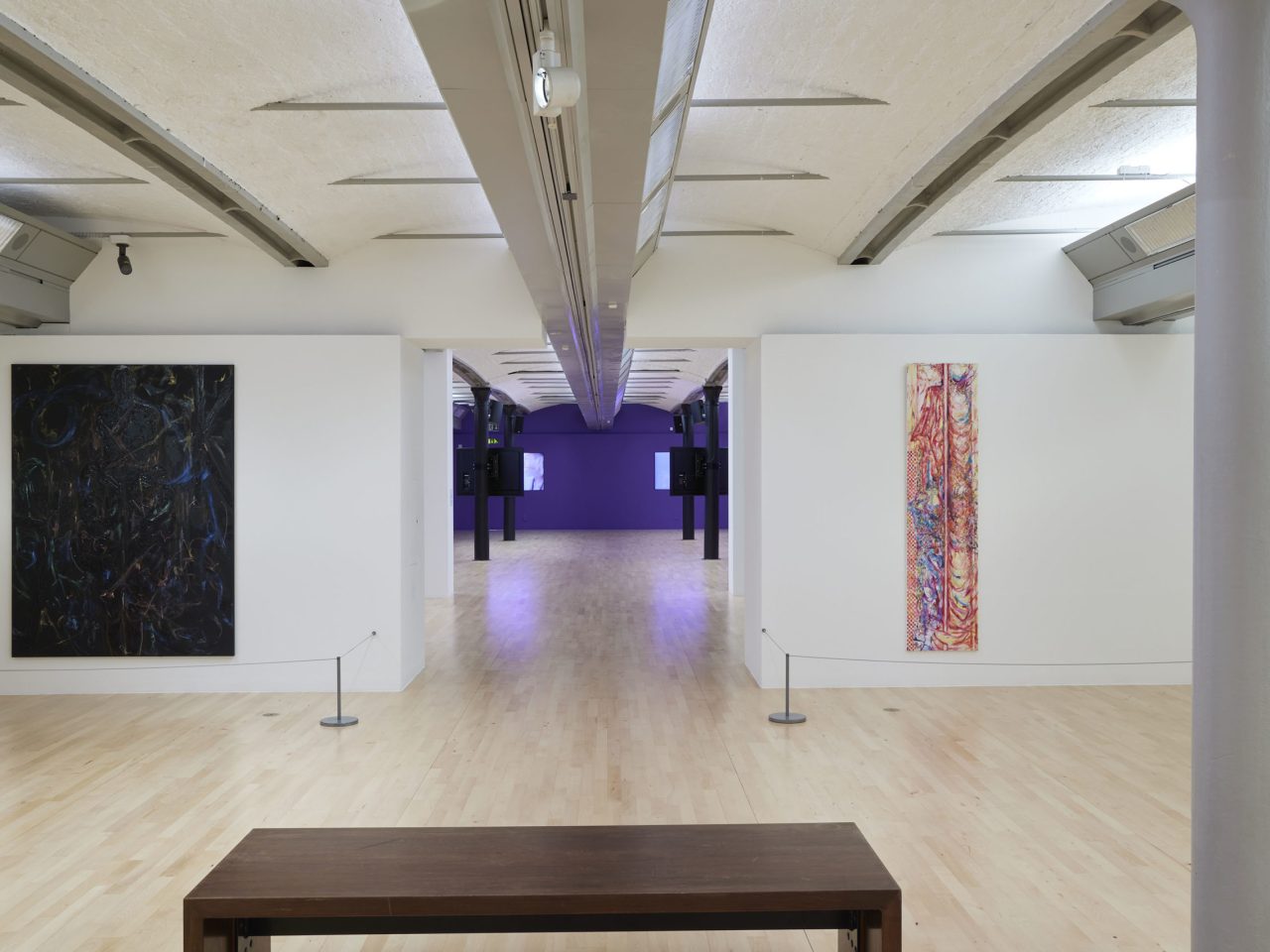 A gallery space with various artworks on the wall.