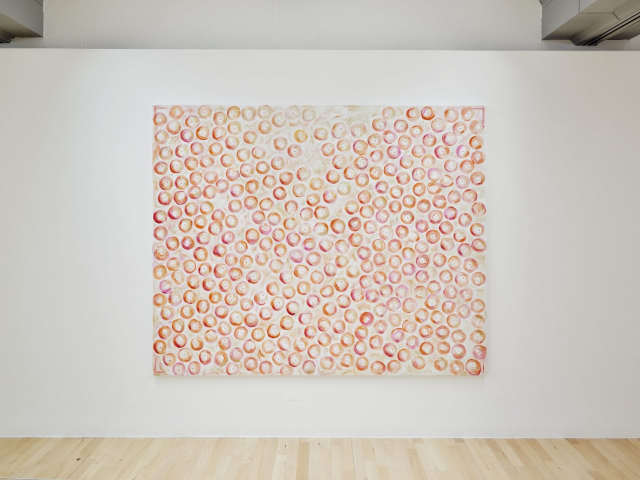 A large painting with various pink and orange circles.