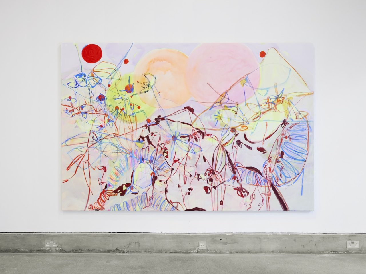 A large abstract painting, mainly light pink with yellow, red and blue markings.