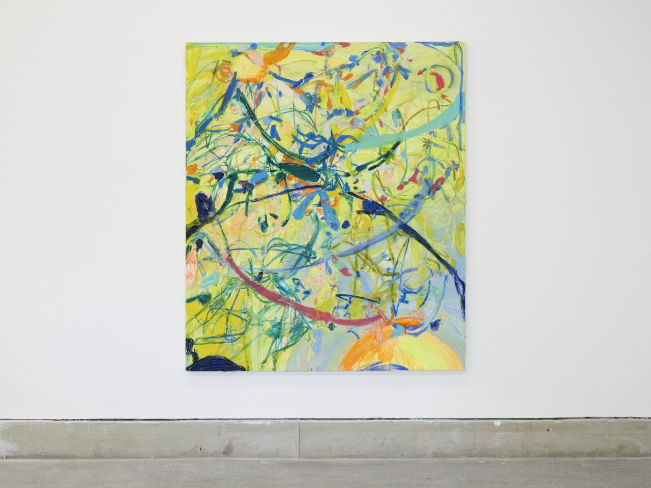 An abstract painting that has a yellow background with brush marks made up with different shades of blue