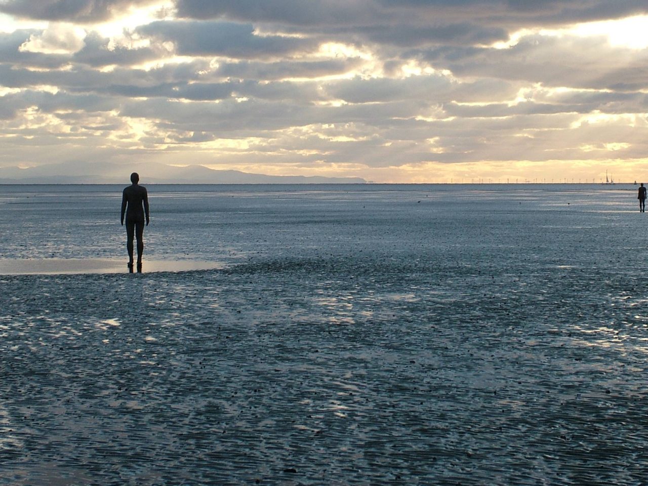 Antony Gormley's 'Another Place' - multiple life-size iron men on Crosby beach
